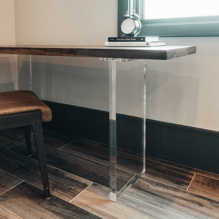 A closeup of acrylic lucite panel table legs under a wooden office desk table available for purchase to add to any existing tabletop.