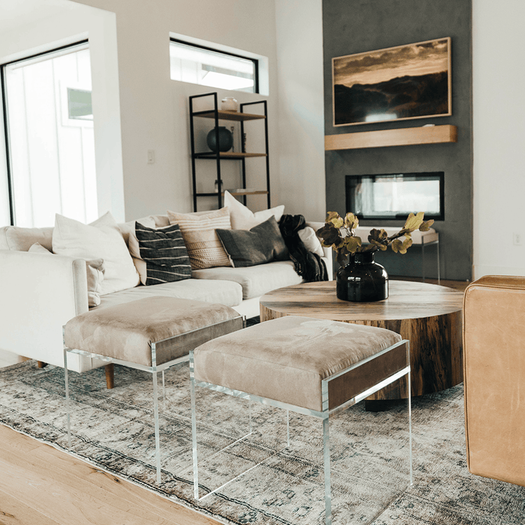 2 acrylic lucite upholstered accent chairs providing extra seating in a living room setting.