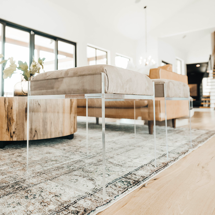 2 acrylic lucite upholstered accent chairs providing extra seating in a living room setting.