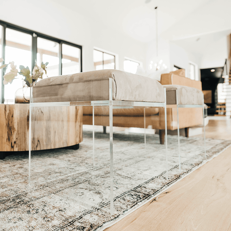 2 acrylic lucite upholstered accent chairs providing extra seating in a living room setting.