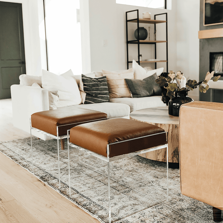2 acrylic lucite upholstered accent chairs providing extra seating in a living room setting.