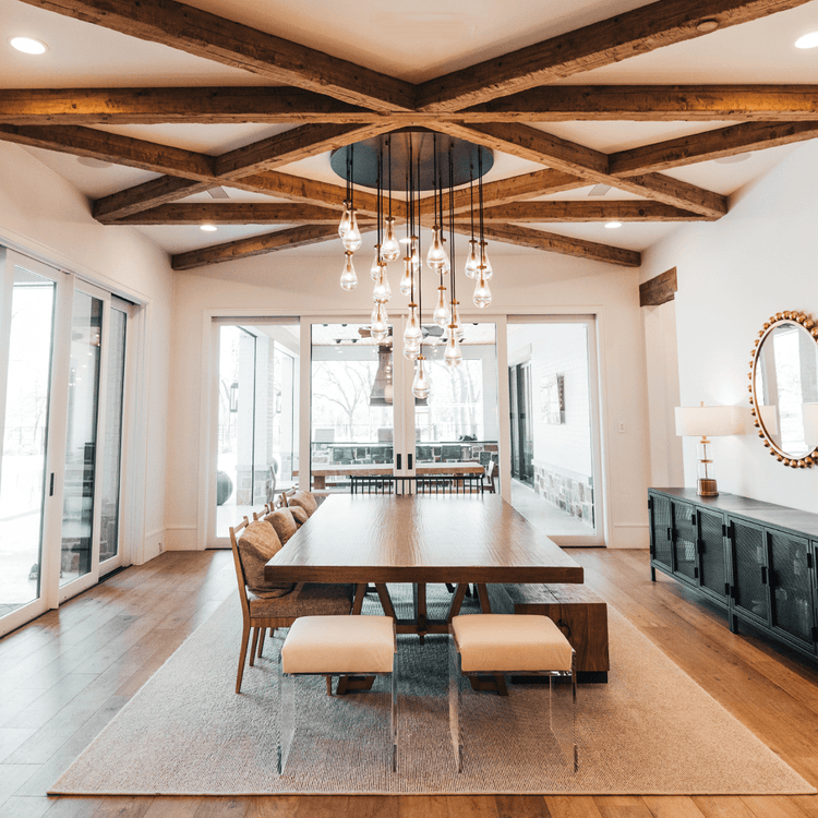 2 acrylic lucite upholstered accent chairs providing extra seating at the end of a dining room table.
