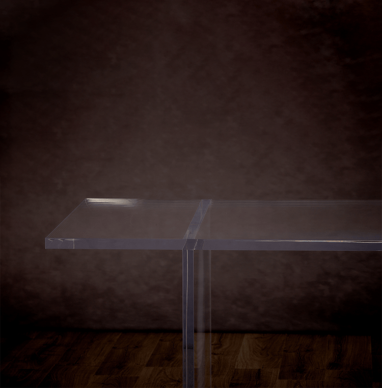 Catalog closeup of 1 end of a clear acrylic slab style dining room table.