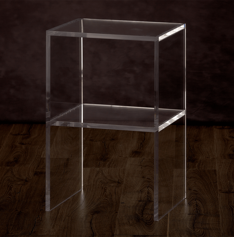 Catalog view of a clear acrylic slab nightstand with 1 interior shelf placed on a hardwood floor.