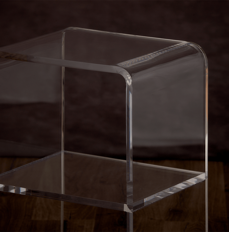 Catalog closeup of the waterfall edge on a clear acrylic nightstand.