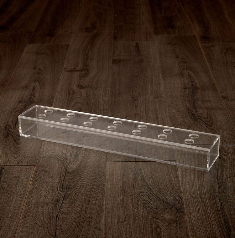 Empty clear acrylic horizontal short stem floral centerpiece showing 7 pairs of individual holes for flower placement.