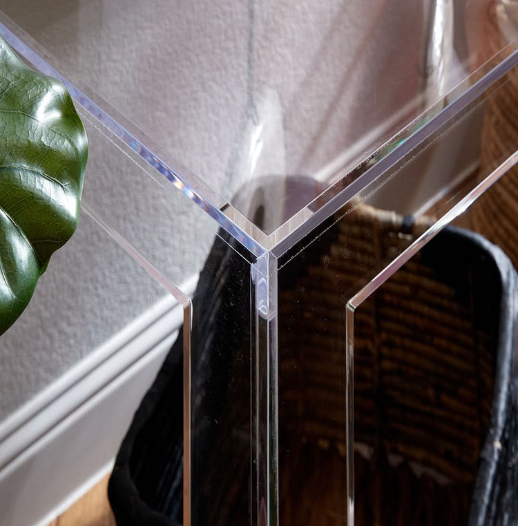 Closeup of the top corner edge on a clear acrylic slab entryway table.