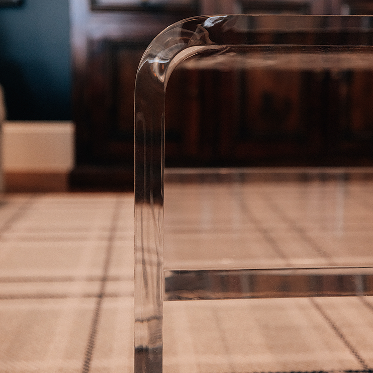 Closeup of the edges on a clear acrylic coffee table. 
