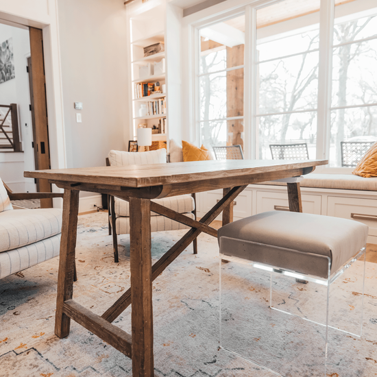 An acrylic lucite upholstered accent chair providing extra seating in an office setting.