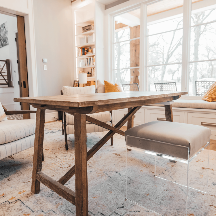 An acrylic lucite upholstered accent chair providing extra seating in an office setting.