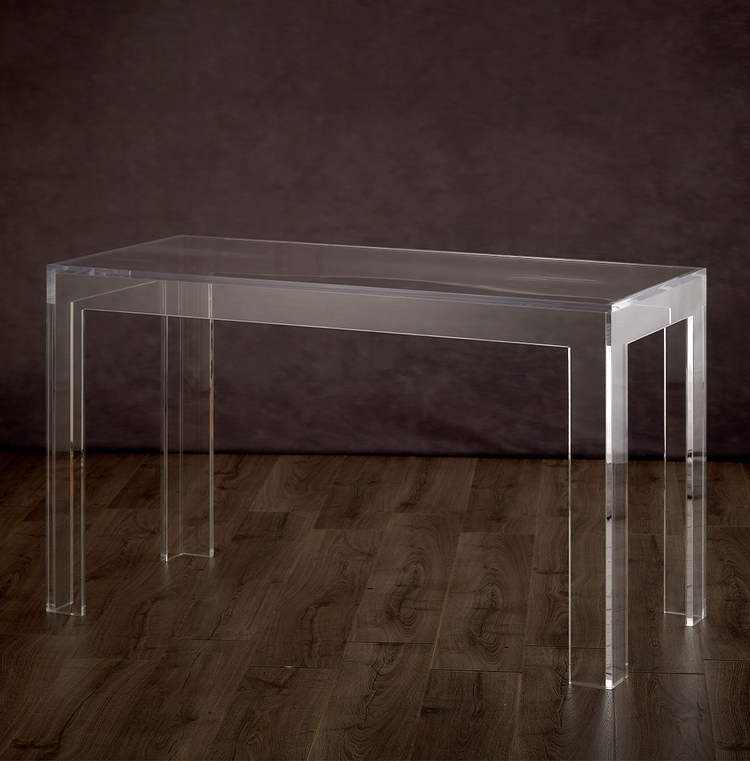 Catalog view of a clear acrylic square leg desk on a hardwood floor.