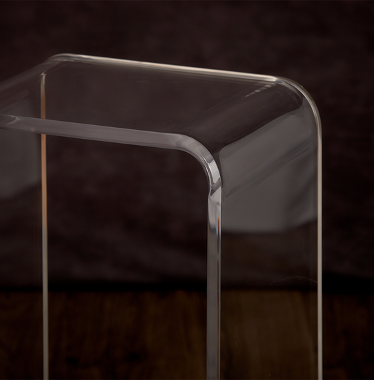 Closeup of the waterfall edge on a clear acrylic end table.