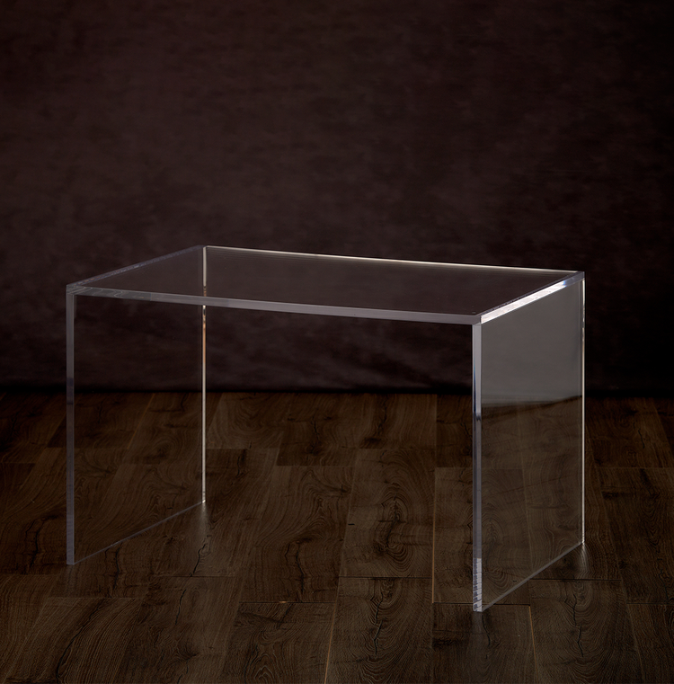 Catalog view of a clear acrylic 23" slab coffee table.