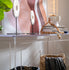 Clear acrylic slab entryway table in front of a modern painting displaying books, artwork, and decor.